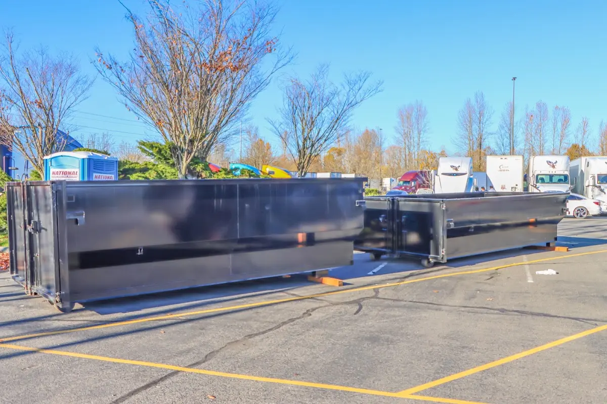 Professional dumpster rental service with roll-off container on residential driveway in Wauseon